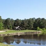Panoramic view of a lush green golf course at Pine Hollow Golf Club. Smooth