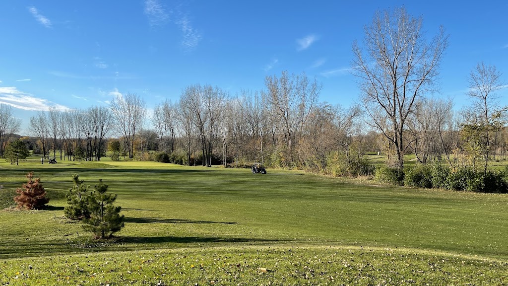 Panoramic view of a lush green golf course at Pine Island Golf Course. Smooth