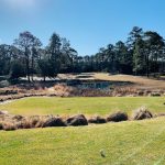 Panoramic view of a lush green golf course at Pine Needles Lodge & Golf Club. Smooth