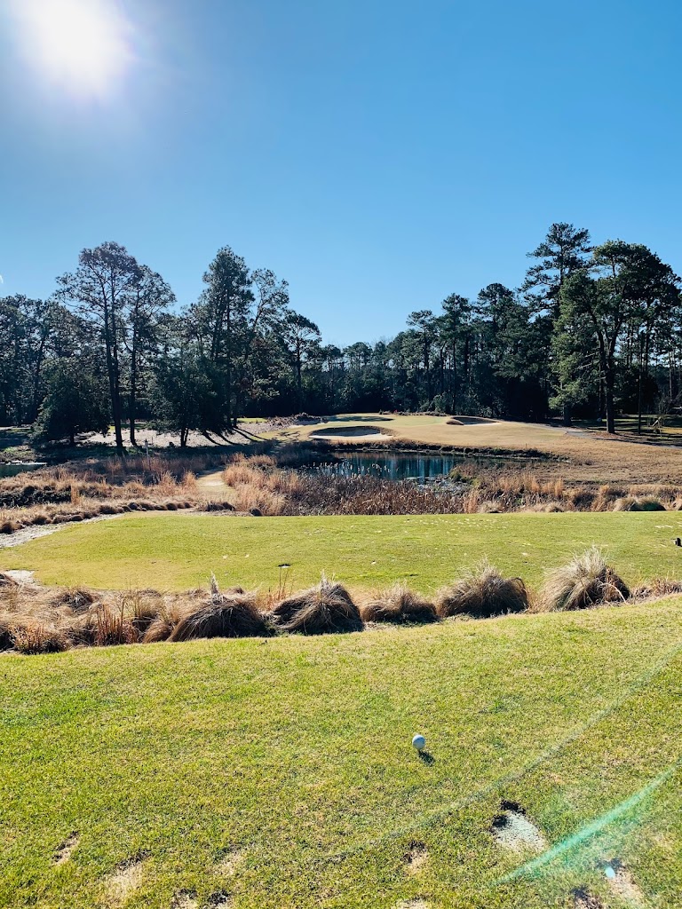Panoramic view of a lush green golf course at Pine Needles Lodge & Golf Club. Smooth