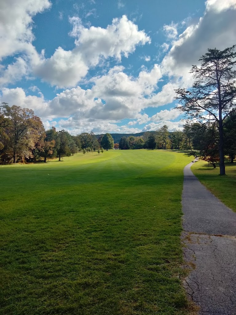 Panoramic view of a lush green golf course at Pine Ridge Golf Course. Smooth