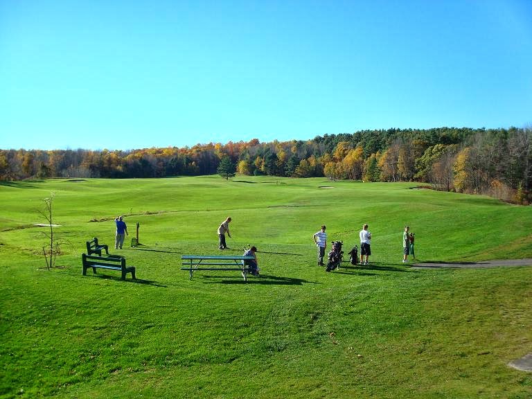 Panoramic view of a lush green golf course at Pine Ridge Municipal Golf Course. Smooth