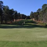 Panoramic view of a lush green golf course at Pinehurst No. 7. Smooth