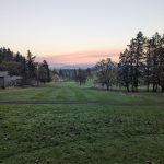 Panoramic view of a lush green golf course at Pineway Golf Course. Smooth
