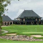 Panoramic view of a lush green golf course at Pinnacle Golf Club. Smooth