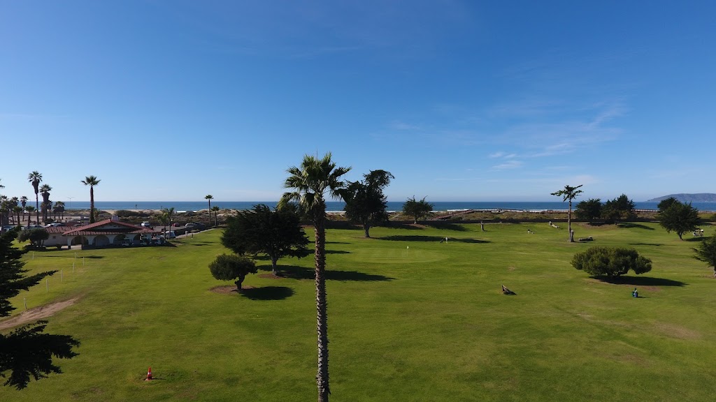 Panoramic view of a lush green golf course at Pismo Beach Golf Course. Smooth