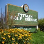 Panoramic view of a lush green golf course at Pitman Golf Course. Smooth