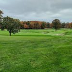 Panoramic view of a lush green golf course at Plainfield Country Club. Smooth