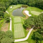 Panoramic view of a lush green golf course at Plantation Lakes Golf & Country Club. Smooth