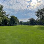 Panoramic view of a lush green golf course at Pleasant Run Golf Course. Smooth