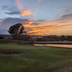 Panoramic view of a lush green golf course at Plum Creek Golf Club. Smooth