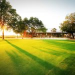 Panoramic view of a lush green golf course at Plum Creek Golf Course. Smooth