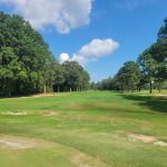 Panoramic view of a lush green golf course at Point Mallard Golf Course. Smooth