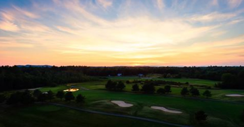 Panoramic view of a lush green golf course at Point Sebago Golf Course. Smooth