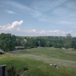 Panoramic view of a lush green golf course at Pointe Royale Village-Country. Smooth