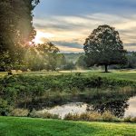 Panoramic view of a lush green golf course at Pomperaug Golf Course. Smooth