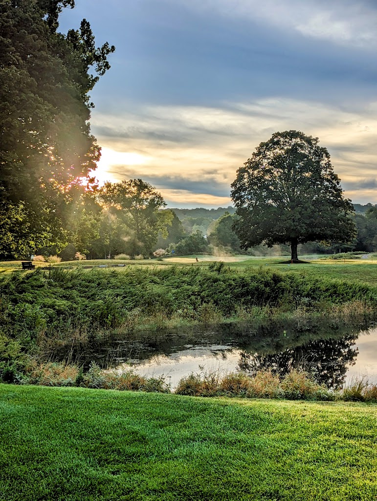 Panoramic view of a lush green golf course at Pomperaug Golf Course. Smooth