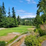 Panoramic view of a lush green golf course at Port Ludlow Golf Course. Smooth