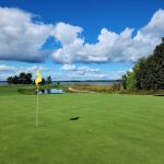 Panoramic view of a lush green golf course at Portsmouth Country Club. Smooth