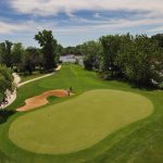 green grass with the flag in the hole.