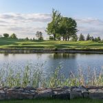 Panoramic view of a lush green golf course at Pound Ridge Golf Club. Smooth