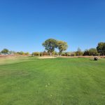 Panoramic view of a lush green golf course at Prairie Dunes Country Club. Smooth