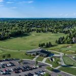 Panoramic view of a lush green golf course at Prairie Green Golf Course. Smooth