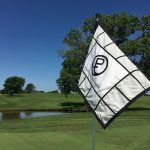 green grass with the flag in the hole.