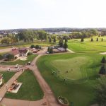 Panoramic view of a lush green golf course at Prairie West Golf Course. Smooth
