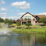 Panoramic view of a lush green golf course at Prairie Woods Golf Course. Smooth