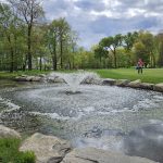 Panoramic view of a lush green golf course at Preakness Valley Golf Course. Smooth