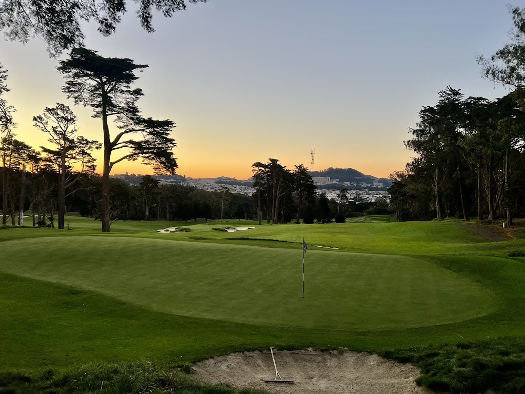 Panoramic view of a lush green golf course at Presidio Golf Course. Smooth
