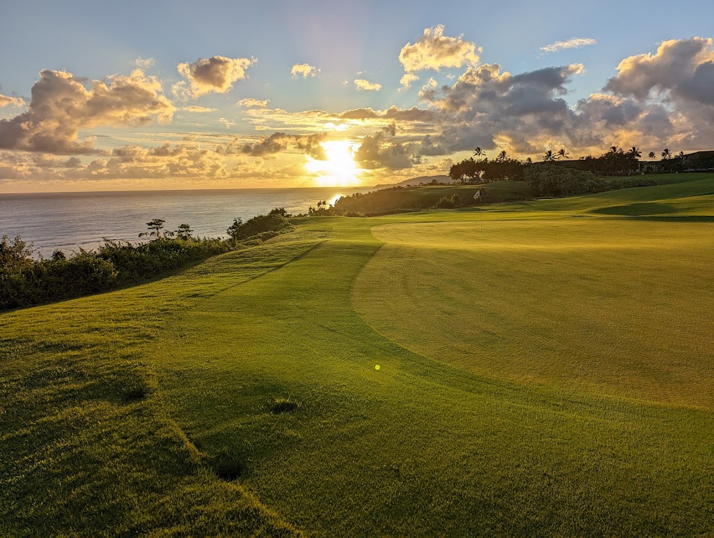 Panoramic view of a lush green golf course at Princeville Makai Golf Club. Smooth