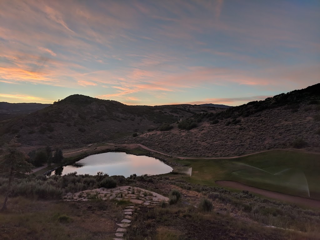 Panoramic view of a lush green golf course at Promontory Pete Dye Golf Course. Smooth