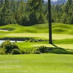 Panoramic view of a lush green golf course at Prospector Golf Course. Smooth
