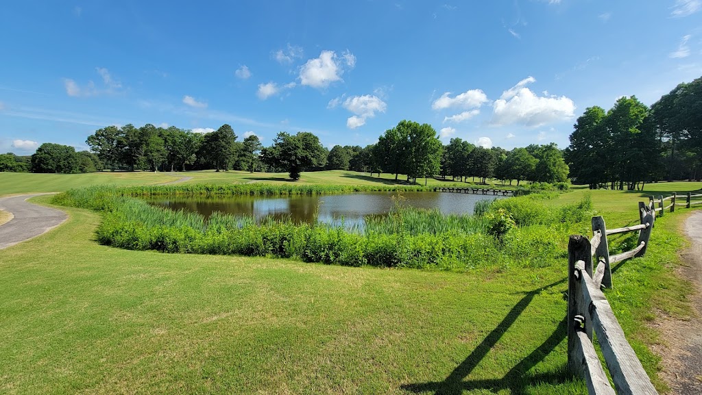 Panoramic view of a lush green golf course at Providence Golf Club. Smooth
