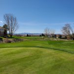 Panoramic view of a lush green golf course at Ptarmigan Country Club. Smooth