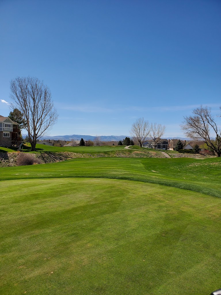 Panoramic view of a lush green golf course at Ptarmigan Country Club. Smooth