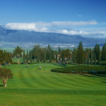 Panoramic view of a lush green golf course at Pukalani Country Club. Smooth
