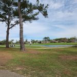 Panoramic view of a lush green golf course at Quail Creek Golf Course. Smooth