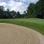 Panoramic view of a lush green golf course at Quail Ridge Golf Course. Smooth