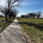 Panoramic view of a lush green golf course at Quail Run Golf Course. Smooth