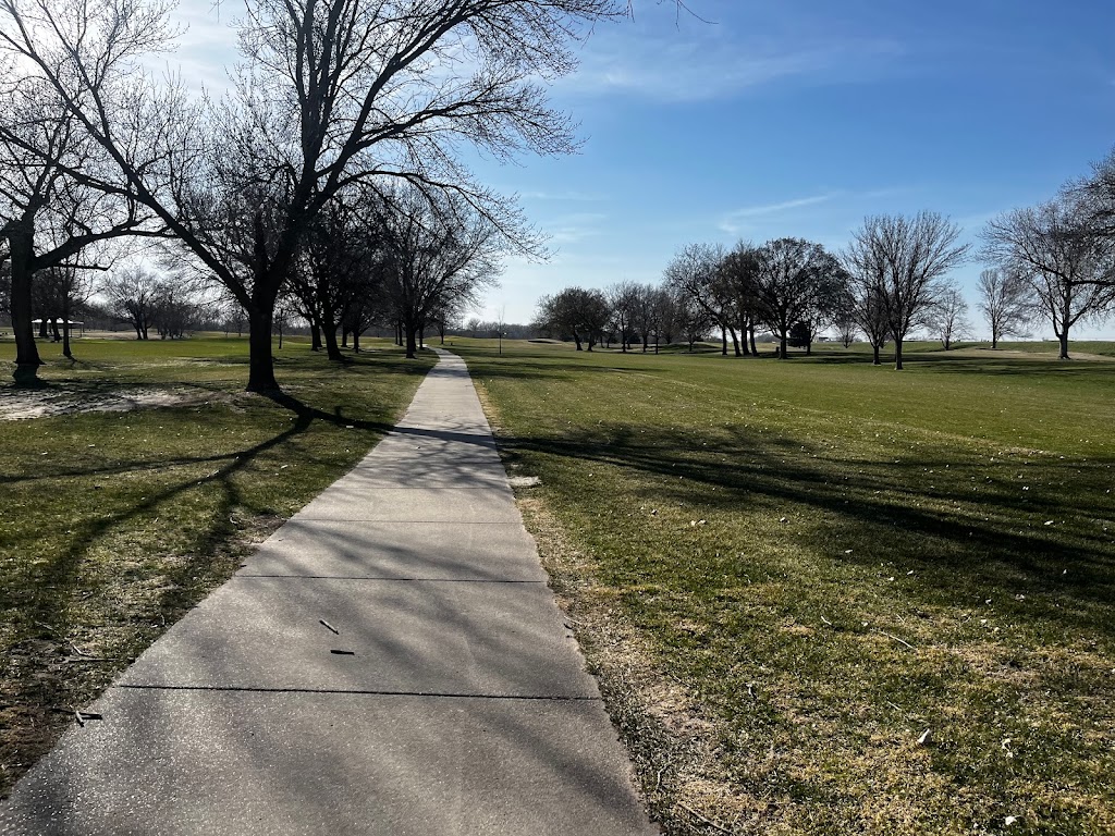 Panoramic view of a lush green golf course at Quail Run Golf Course. Smooth