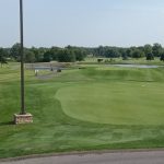 green grass with the flag in the hole.