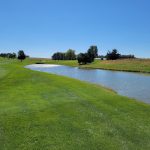 Panoramic view of a lush green golf course at Quail Valley Golf Course. Smooth