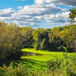 Panoramic view of a lush green golf course at Quarry Oaks Golf Club. Smooth