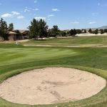 green grass with the flag in the hole.