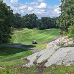 Panoramic view of a lush green golf course at Quarry Ridge Golf Course. Smooth