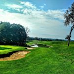 Panoramic view of a lush green golf course at Quicksilver Golf Club. Smooth