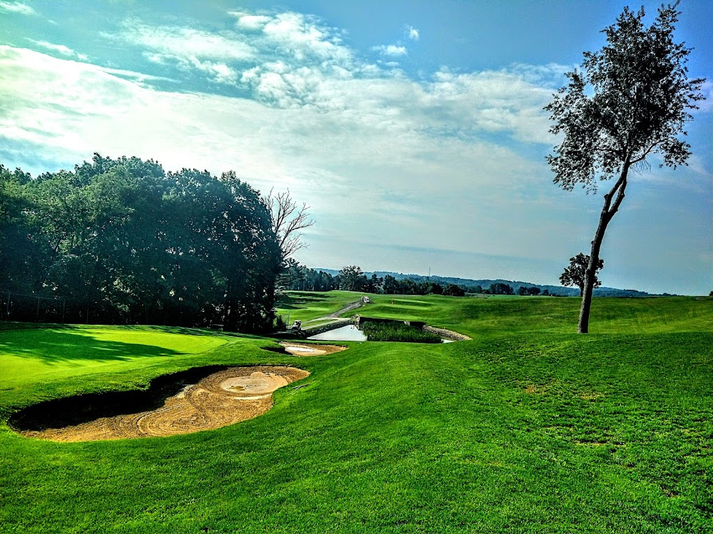 Panoramic view of a lush green golf course at Quicksilver Golf Club. Smooth